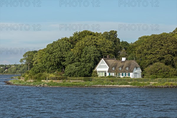 Thatched roof house on the shore