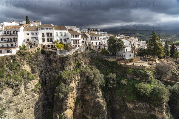 The white houses of the old town La Ciudad on a rocky plateau above the gorge Tajo de Ronda