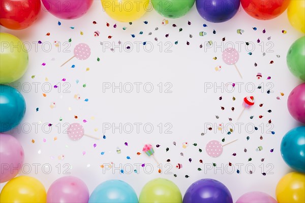 Colorful balloons border with confetti props white background