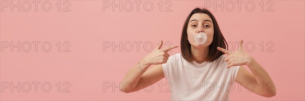 Girl pointing bubble gum