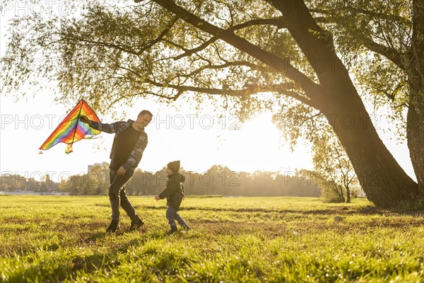 Father son playing kite park