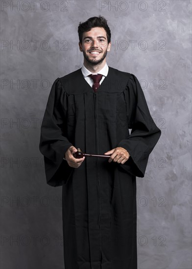 Front view smiley judge robe holding wooden gavel