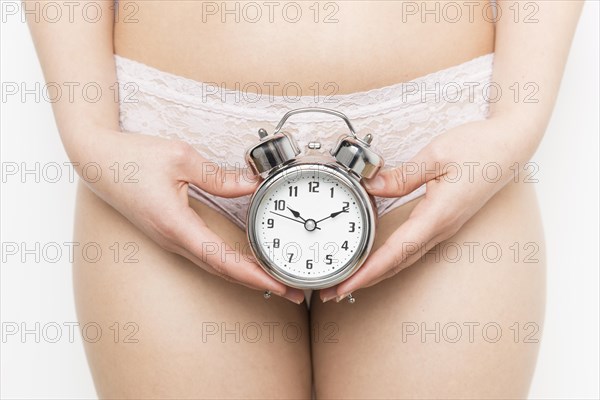 Girl holding alarm clock