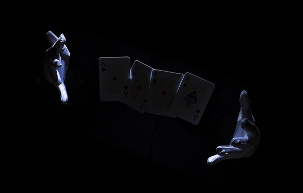 Magician s hand performing trick with playing card