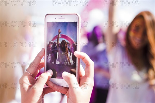 Close up woman taking her friend mobile phone