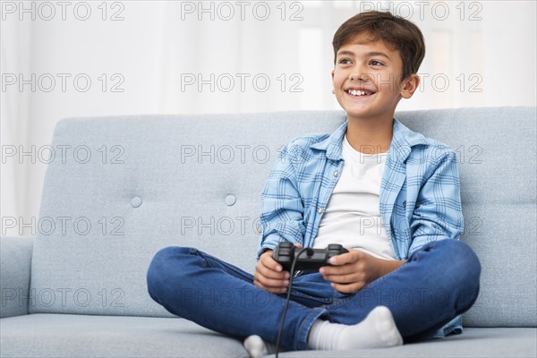 Low angle boy playing with joystick