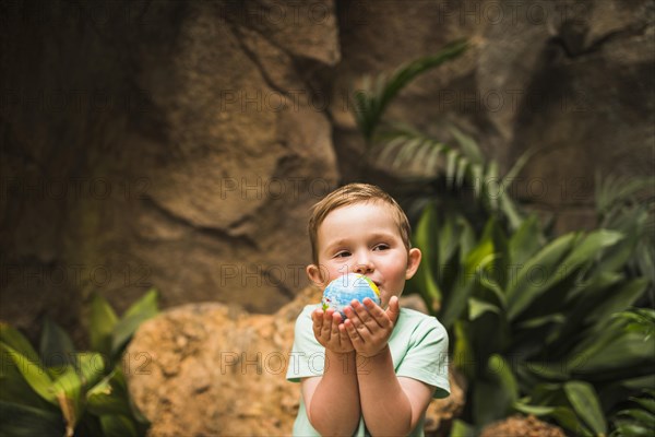 Portrait boy holding globe hand