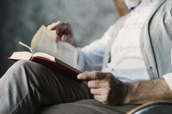 Close up man turning pages book