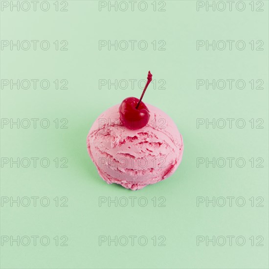 Pink ice cream ball with cherry