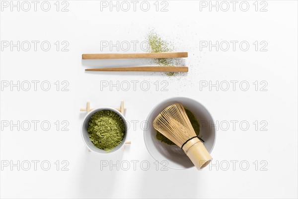 Top view matcha concept with bamboo whisk
