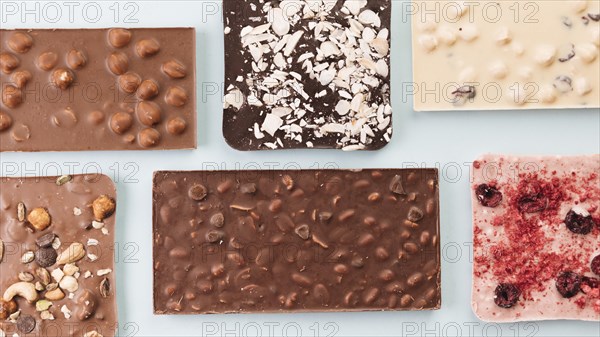 Top view chocolate bars with nuts berries