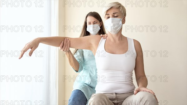 Female patient undergoing therapy physiotherapist