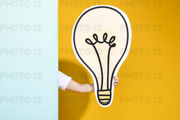 Portrait schoolgirl with big light bulb
