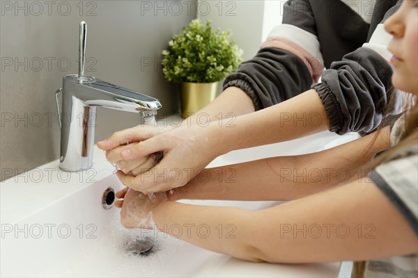 Close up mother child washing hands