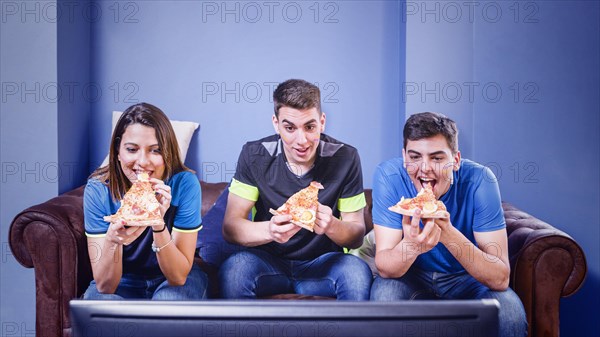 Football fans couch looking tv