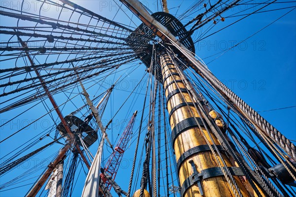 Masts of old wooden Age of sail sailing ship with ropes cordage and shroud and crow's nest