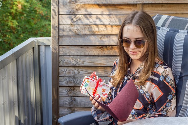 Nice young pretty girl holding a gift