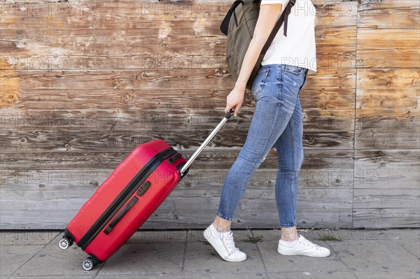 Side view woman with her luggage