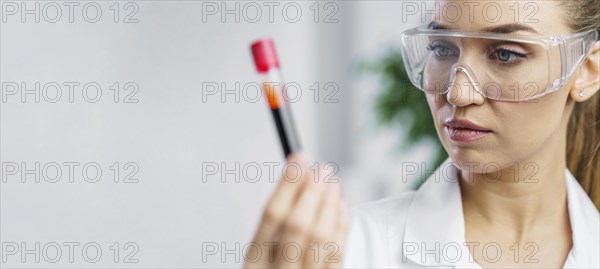 Portrait female researcher lab with test tube copy space