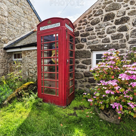 Red telephone box with defibrillator inscription