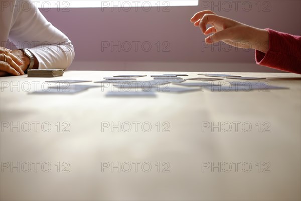 A child plays memory with his grandma