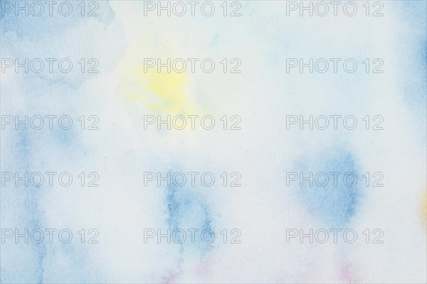 Blue yellow spots paints white paper