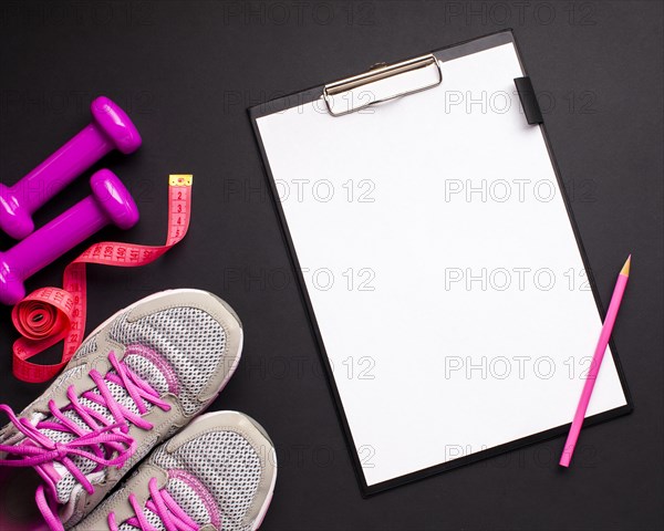 Flat lay pink sports attributes with clipboard