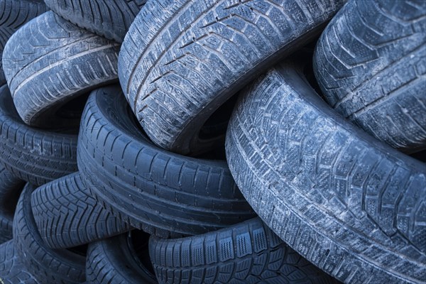 Pile of worn old tyres from passenger cars