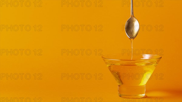 Honey dripping off spoon bowl
