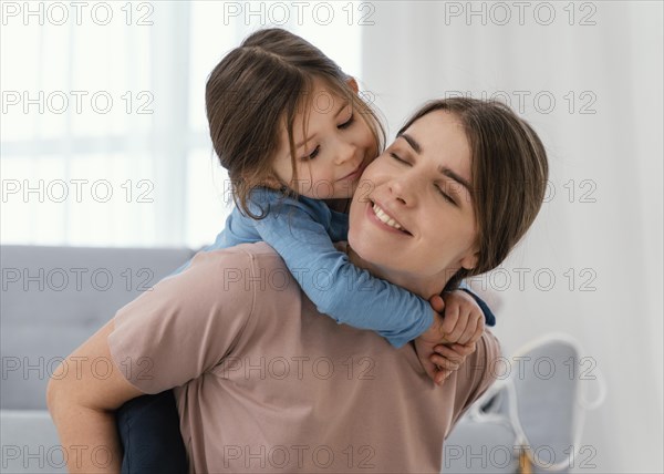 Close up smiley mother holding kid