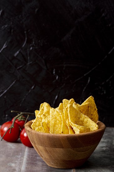 Tasty nachos wooden bowl tomatoes