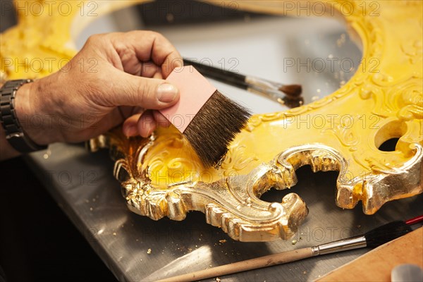 Detail of a mirror gilded with gold leaf