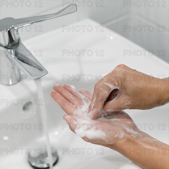 Person washing hands with soap