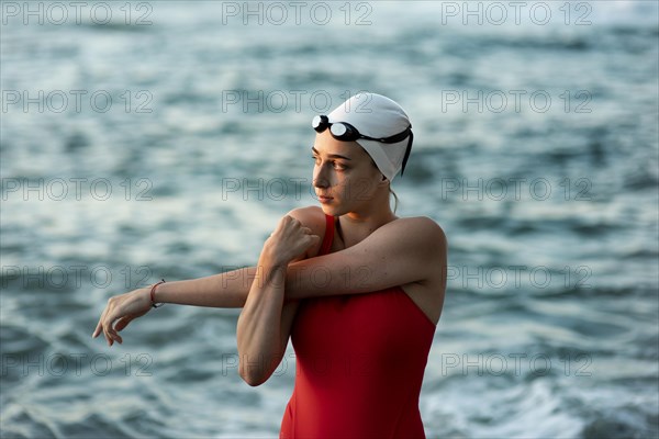 Front view female swimmer stretching before swimming