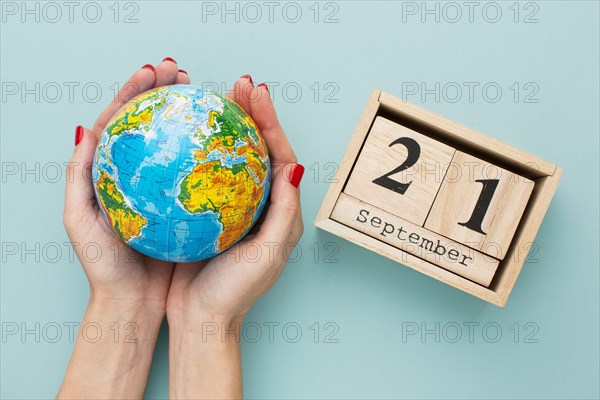 Top view hands holding earth globe calendar
