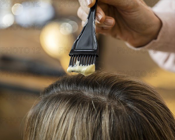 Woman getting her hair dyed home by hairdresser