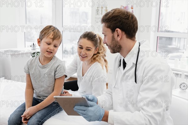 Medium shot doctor holding tablet