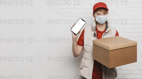 Medium shot guy holding box phone