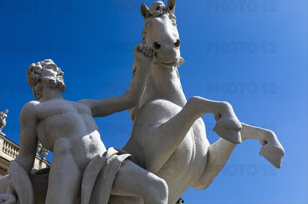 Stone horse and rider figure in front of the Belvedere Upper Baroque Palace