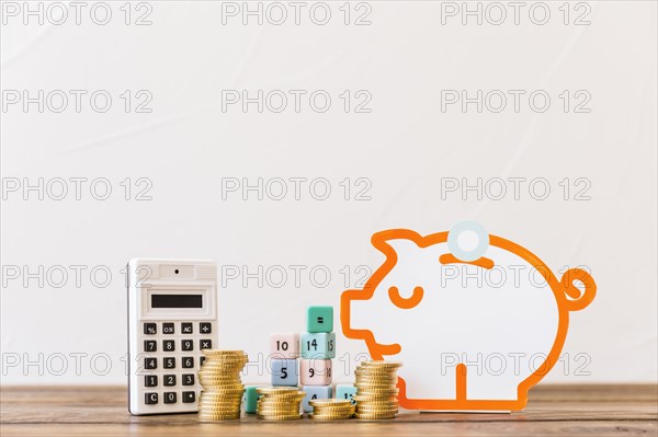 Stacked coins math blocks calculator piggybank wooden tabletop