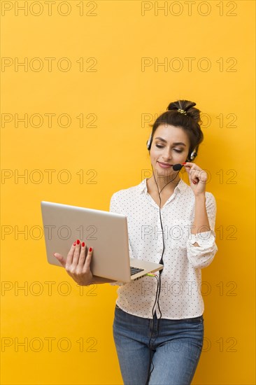 Front view woman wearing headset taking clients laptop