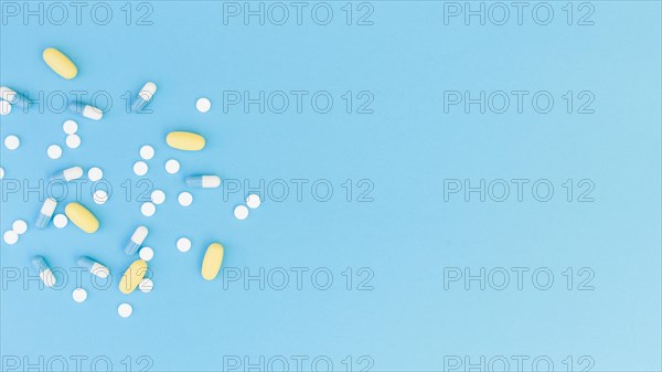 Top view medical pills capsules blue background