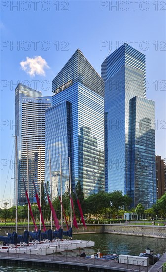 Group of buildings in CBD or Central Business District buildings over Marina Bay waters and catamaran boat jetty in day light