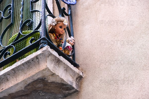Two dolls on a balcony in Lisbon