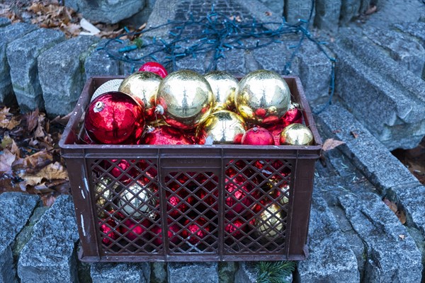 Red and golden Christmas tree balls in a plastic basket