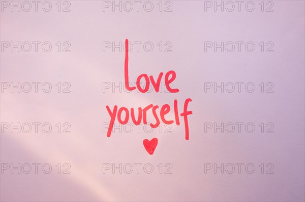 Love yourself inscription purple table