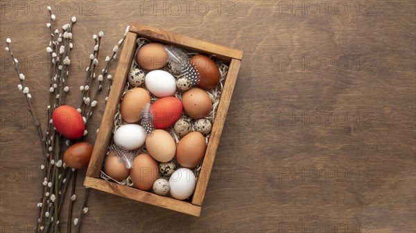 Flat lay box with eggs easter copy space