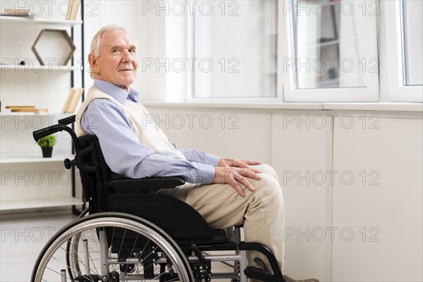 Side view elder sitting wheelchair