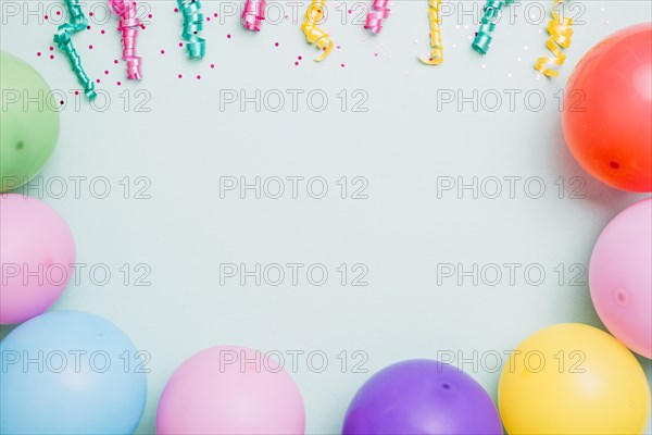 Streamers colorful balloons blue backdrop space text