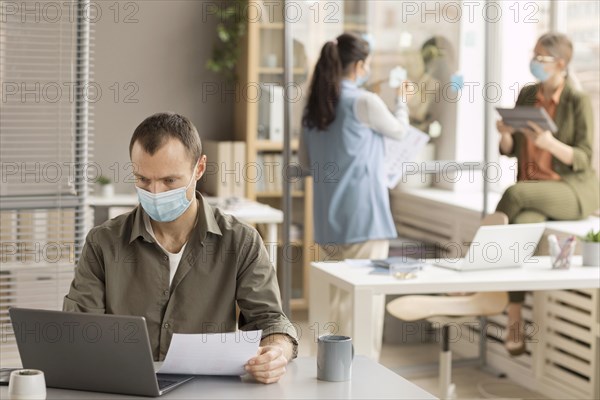 Employees working with face masks